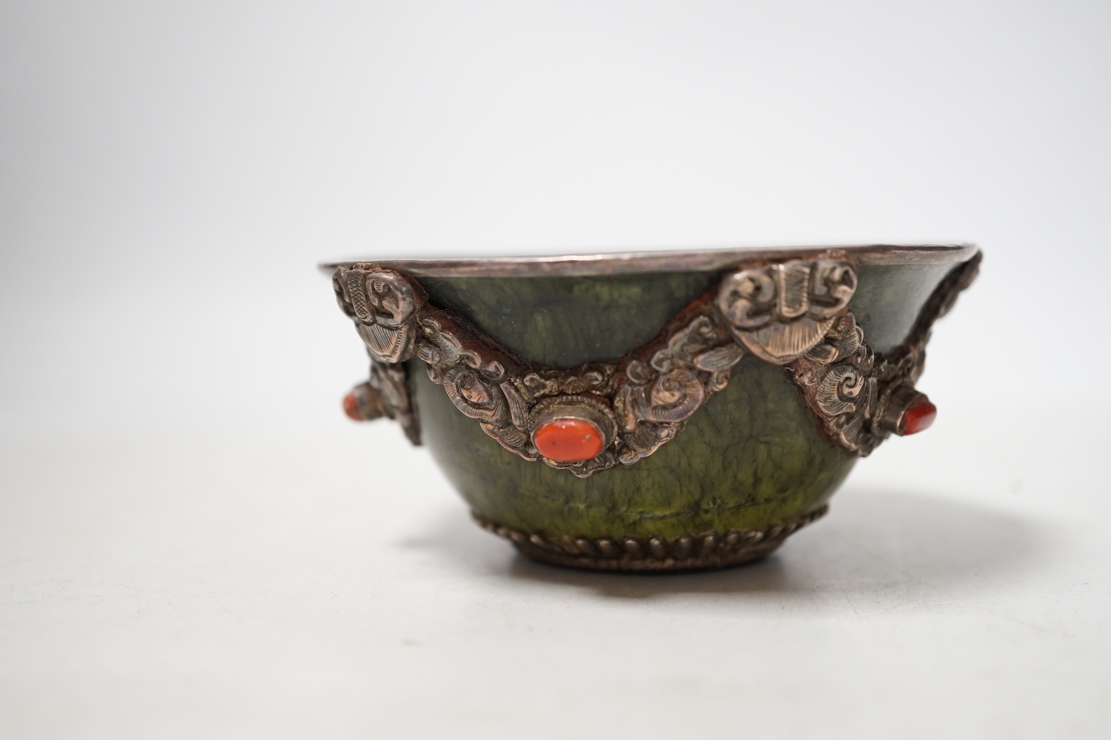A Tibetan silver cup and a silver mounted hard stone bowl